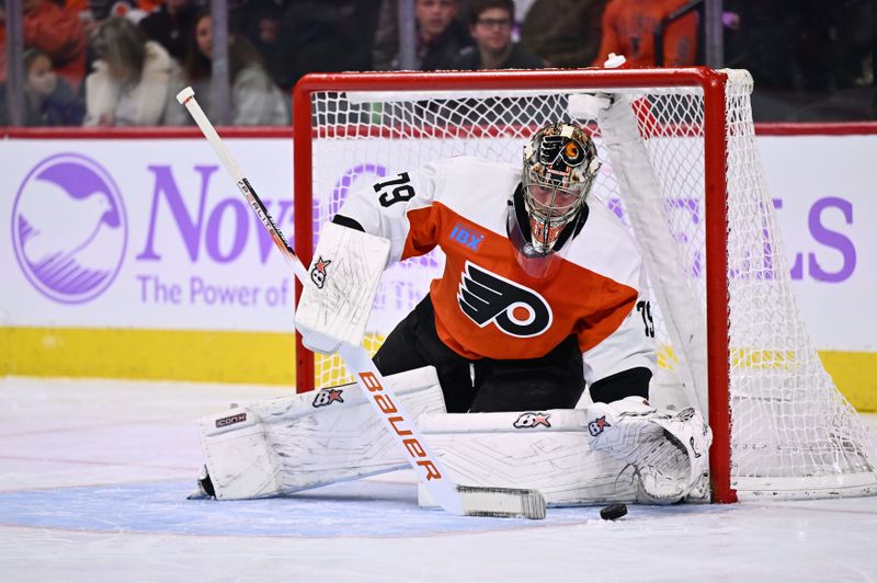 Nov 28, 2023; Philadelphia, Pennsylvania, USA; Philadelphia Flyers goalie Carter Hart (79) covers the puck against the Carolina Hurricanes in the first period at Wells Fargo Center. Mandatory Credit: Kyle Ross-USA TODAY Sports