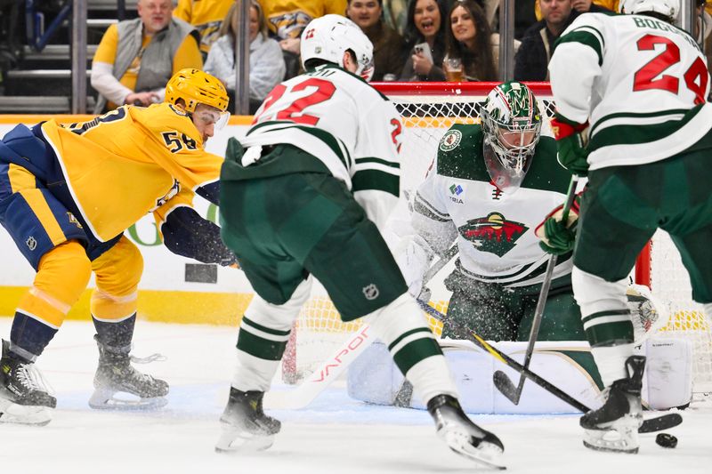 Feb 4, 2026; Nashville, Tennessee, USA;  Minnesota Wild goaltender Filip Gustavsson (32) blocks the shot of Nashville Predators left wing Michael Bunting (58) during the third period at Bridgestone Arena. Mandatory Credit: Steve Roberts-Imagn Images