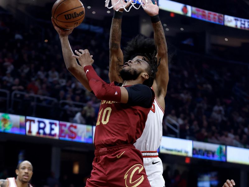 CLEVELAND, OH - FEBRUARY 14: Darius Garland #10 of the Cleveland Cavaliers goes up for a shot against Coby White #0 of the Chicago Bulls during the first half at Rocket Mortgage Fieldhouse on February 14, 2024 in Cleveland, Ohio. NOTE TO USER: User expressly acknowledges and agrees that, by downloading and or using this photograph, User is consenting to the terms and conditions of the Getty Images License Agreement. (Photo by Ron Schwane/Getty Images)