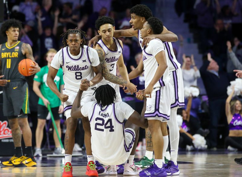 Jan 16, 2024; Manhattan, Kansas, USA; Kansas State Wildcats forward Arthur Maluma (24) is helped off the floor by teammates after hitting the game-winning three-point basket in overtime against the Baylor Bears at Bramlage Coliseum. Mandatory Credit: Scott Sewell-USA TODAY Sports