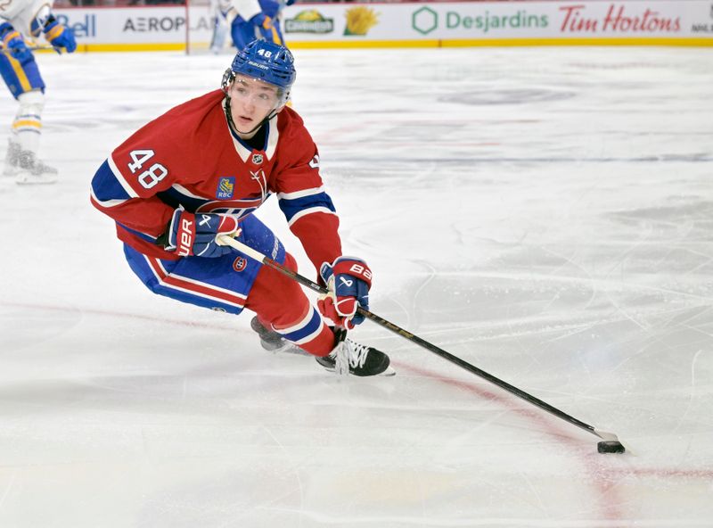 Mar 3, 2025; Montreal, Quebec, CAN; Montreal Canadiens defenseman Lane Hutson (48) plays the puck during the third period of the game against the Buffalo Sabres at the Bell Centre. Mandatory Credit: Eric Bolte-Imagn Images