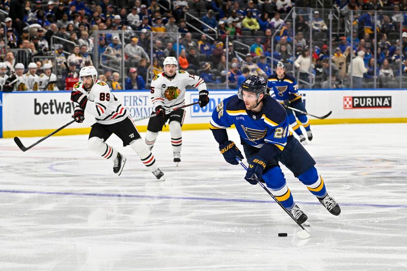 Apr 10, 2024; St. Louis, Missouri, USA;  St. Louis Blues left wing Nathan Walker (26) controls the puck against the Chicago Blackhawks during the second period at Enterprise Center. Mandatory Credit: Jeff Curry-USA TODAY Sports