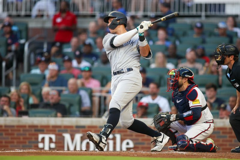 Aug 16, 2023; Atlanta, Georgia, USA; New York Yankees designated hitter Aaron Judge (99) hits a single against the Atlanta Braves in the fourth inning at Truist Park. Mandatory Credit: Brett Davis-USA TODAY Sports