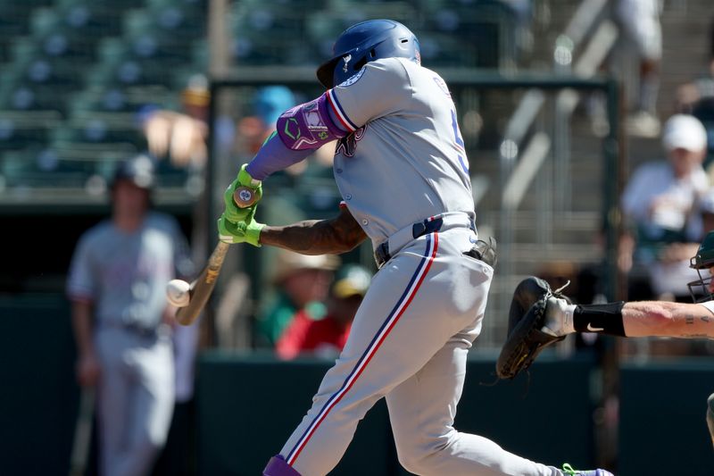 Aug 31, 2025; West Sacramento, California, USA; Texas Rangers right fielder Adolis Garcia (53) hits an RBI single against the Athletics during the seventh inning at Sutter Health Park. Mandatory Credit: Dennis Lee-Imagn Images