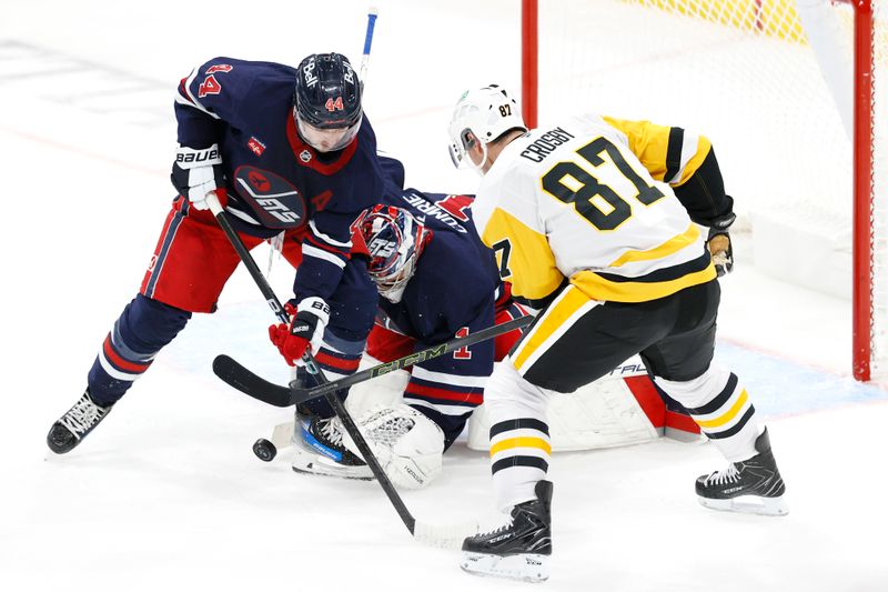 Oct 20, 2024; Winnipeg, Manitoba, CAN; Winnipeg Jets defenseman Josh Morrissey (44) and Pittsburgh Penguins center Sidney Crosby (87) scramble for a rebound in front of Winnipeg Jets goaltender Eric Comrie (1) in the third period at Canada Life Centre. Mandatory Credit: James Carey Lauder-Imagn Images