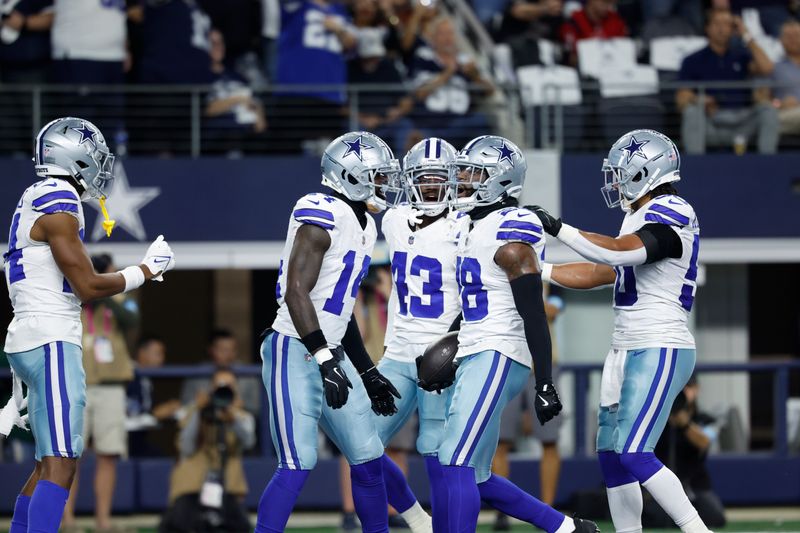 Dallas Cowboys defensive players celebrate an interception including Malik Hooker (28) during an NFL football game against the Houston Texans on Monday, Nov. 18, 2024, in Arlington, Texas. (AP Photo/Matt Patterson)