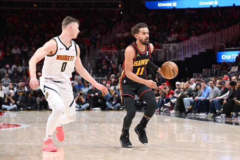 ATLANTA, GA - DECEMBER 8: Trae Young #11 of the Atlanta Hawks dribbles the ball during the game against the Denver Nuggets on December 8, 2024 at State Farm Arena in Atlanta, Georgia.  NOTE TO USER: User expressly acknowledges and agrees that, by downloading and/or using this Photograph, user is consenting to the terms and conditions of the Getty Images License Agreement. Mandatory Copyright Notice: Copyright 2024 NBAE (Photo by Adam Hagy/NBAE via Getty Images)