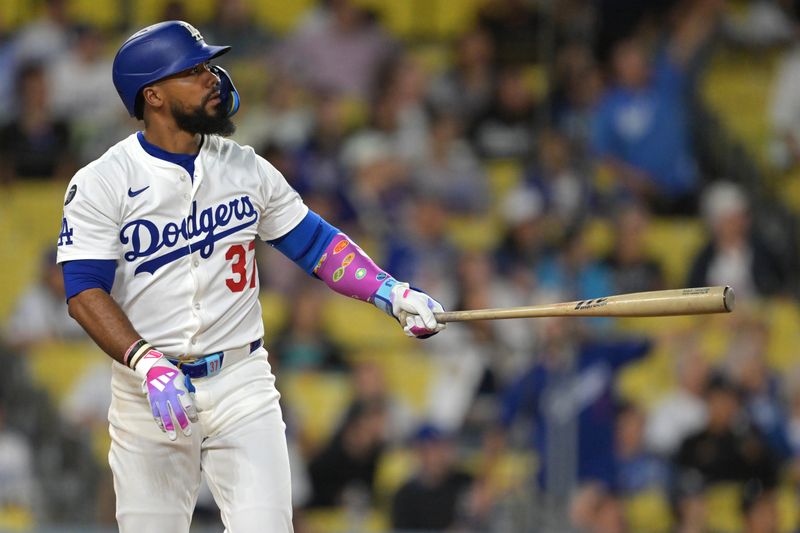 Sep 10, 2025; Los Angeles, California, USA; Los Angeles Dodgers right fielder Teoscar Hernandez (37) hits solo home run during the eighth inning against the Colorado Rockies at Dodger Stadium. Mandatory Credit: Jayne Kamin-Oncea-Imagn Images