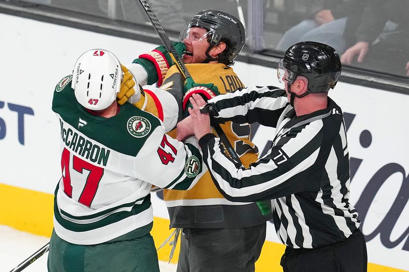Mar 6, 2026; Las Vegas, Nevada, USA; Vegas Golden Knights defenseman Jeremy Lauzon (5) shoves Minnesota Wild center Michael McCarron (47) during the third period at T-Mobile Arena. Mandatory Credit: Stephen R. Sylvanie-Imagn Images