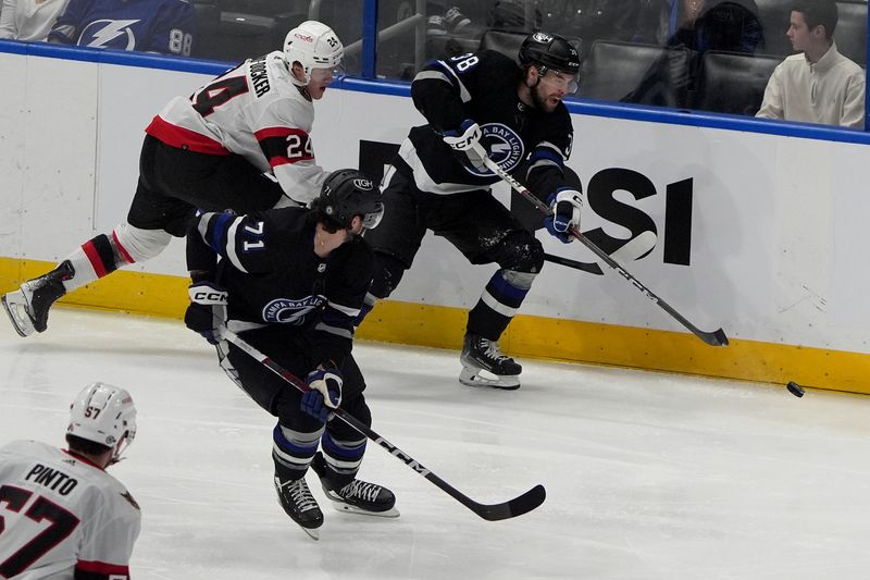 Feb 19, 2024; Tampa, Florida, USA;  Tampa Bay Lightning left wing Brandon Hagel moves the puck against Ottawa Senators defenseman Jacob Bernard-Docker during the first period at Amalie Arena. Mandatory Credit: Dave Nelson-USA TODAY Sports