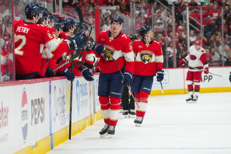 Dec 23, 2025; Raleigh, North Carolina, USA;  Florida Panthers defenseman Niko Mikkola (77) celebrates his goal against the Carolina Hurricanes during the third period at Lenovo Center. Mandatory Credit: James Guillory-Imagn Images