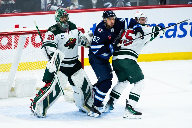 Feb 20, 2024; Winnipeg, Manitoba, CAN; Winnipeg Jets forward Nino Niederreiter (62) jostles for position with Minnesota Wild defenseman Jonas Brodin (25) during the third period at Canada Life Centre. Mandatory Credit: Terrence Lee-USA TODAY Sports