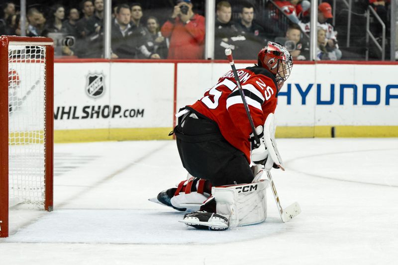 Oct 19, 2024; Newark, New Jersey, USA; New Jersey Devils goaltender Jacob Markstrom (25) makes a save against the Washington Capitals during the third period at Prudential Center. Mandatory Credit: John Jones-Imagn Images