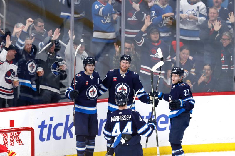 Apr 4, 2024; Winnipeg, Manitoba, CAN; Winnipeg Jets center Gabriel Vilardi (13) celebrates his third period goal against the Calgary Flames with Winnipeg Jets teammates at Canada Life Centre. Mandatory Credit: James Carey Lauder-USA TODAY Sports