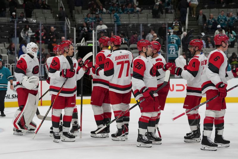 Oct 14, 2025; San Jose, California, USA;  Carolina Hurricanes celebrate after defeating the San Jose Sharks at SAP Center at San Jose. Mandatory Credit: Stan Szeto-Imagn Images