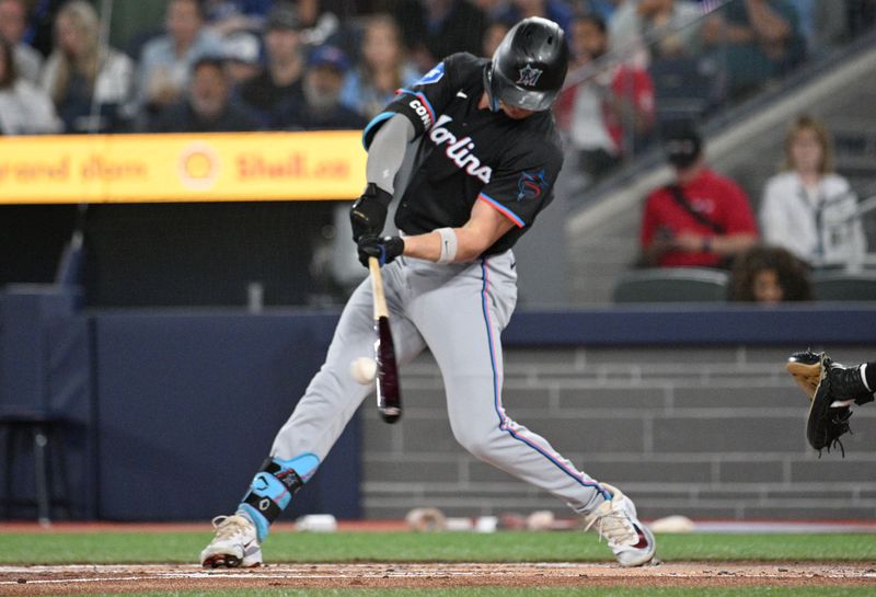 Sep 28, 2024; Toronto, Ontario, CAN;   Miami Marlins left fielder Griffin Conine (58) hits an RBI double against the Toronto Blue Jays in the first inning at Rogers Centre. Mandatory Credit: Dan Hamilton-Imagn Images