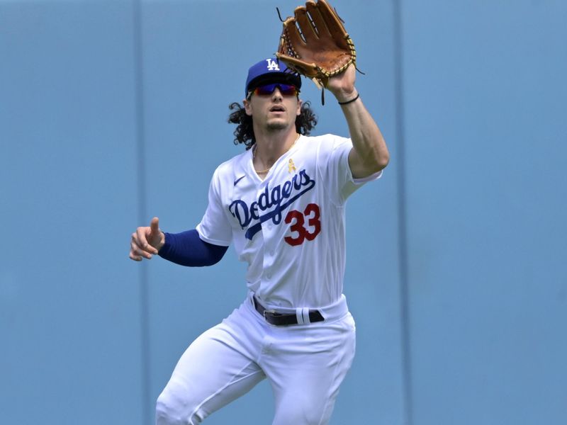 Sep 3, 2023; Los Angeles, California, USA; Los Angeles Dodgers center fielder James Outman (33) makes a catch against the Atlanta Braves in the second inning at Dodger Stadium. Mandatory Credit: Jayne Kamin-Oncea-USA TODAY Sports