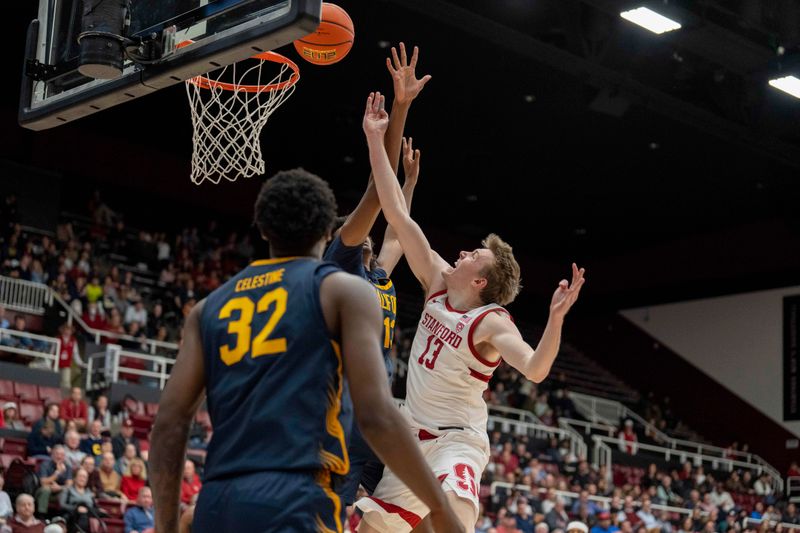 Mar 7, 2024; Stanford, California, USA; Stanford Cardinal guard Michael Jones (13) shoots a layup against California Golden Bears forward Devin Curtis (13) during the second half at Maples Pavillion. Mandatory Credit: Neville E. Guard-USA TODAY Sports