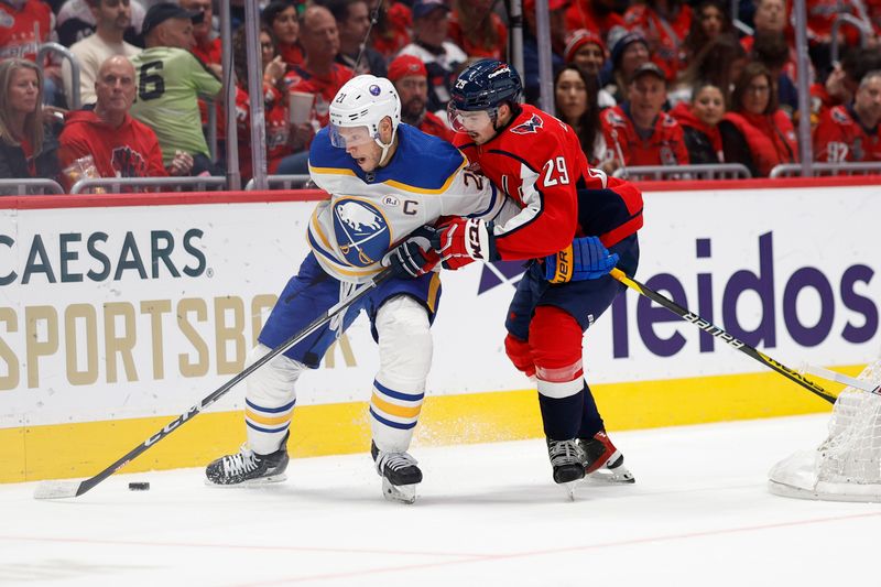 Nov 22, 2023; Washington, District of Columbia, USA; Buffalo Sabres right wing Kyle Okposo (21) and Washington Capitals center Hendrix Lapierre (29) battle for the puck in the second period at Capital One Arena. Mandatory Credit: Geoff Burke-USA TODAY Sports