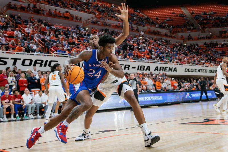 Jan 16, 2024; Stillwater, Oklahoma, USA; Kansas Jayhawks forward K.J. Adams Jr. (24) drives past Oklahoma State Cowboys center Brandon Garrison (23) during the second half at Gallagher-Iba Arena. Mandatory Credit: William Purnell-USA TODAY Sports