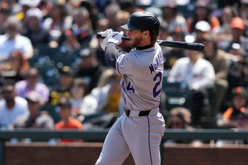 May 3, 2025; San Francisco, California, USA; Colorado Rockies third baseman Ryan McMahon (24) hits an RBI single against the San Francisco Giants during the sixth inning at Oracle Park. Mandatory Credit: Darren Yamashita-Imagn Images