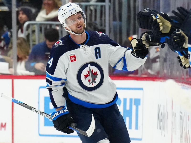 Dec 7, 2023; Denver, Colorado, USA; Winnipeg Jets defenseman Josh Morrissey (44) celebrates his goal in the second period against the Colorado Avalanche at Ball Arena. Mandatory Credit: Ron Chenoy-USA TODAY Sports