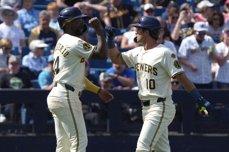 Mar 16, 2025; Phoenix, Arizona, USA; Milwaukee Brewers outfielder Sal Frelick (10) celebrates with third base Andruw Monasterio (14) after hitting a two run home run against the Cleveland Guardians in the third inning at American Family Fields of Phoenix. Mandatory Credit: Rick Scuteri-Imagn Images