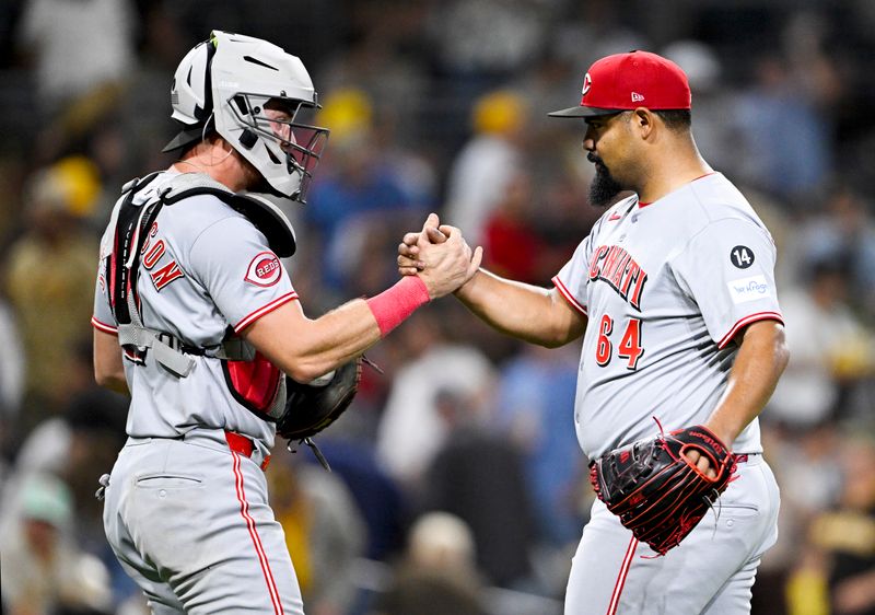 Sep 10, 2025; San Diego, California, USA; Cincinnati Reds catcher Tyler Stephenson (37) and relief pitcher Tony Santillan (64) celebrate after the Reds beat the San Diego Padres at Petco Park. Mandatory Credit: Denis Poroy-Imagn Images