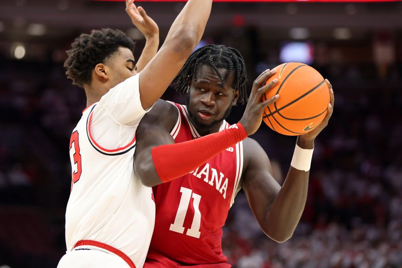 Jan 17, 2025; Columbus, Ohio, USA; Indiana Hoosiers center Oumar Ballo (11) controls the ball as Ohio State Buckeyes forward Sean Stewart (13) defends during the first half at Value City Arena. Mandatory Credit: Joseph Maiorana-Imagn Images