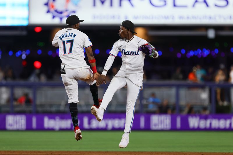 May 1, 2024; Miami, Florida, USA; Miami Marlins center fielder Jazz Chisholm Jr. (2) celebrates with shortstop Vidal Brujan (17) after the game against the Colorado Rockies at loanDepot Park. Mandatory Credit: Sam Navarro-USA TODAY Sports