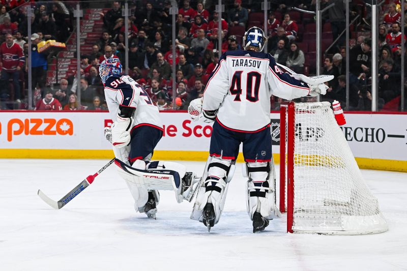 Mar 12, 2024; Montreal, Quebec, CAN; Columbus Blue Jackets goalie Elvis Merzlikins (90) skates back to the locker room while looking towards the bench as goalie Daniil Tarasov (40) takes over the net against the Montreal Canadiens  during the first period at Bell Centre. Mandatory Credit: David Kirouac-USA TODAY Sports