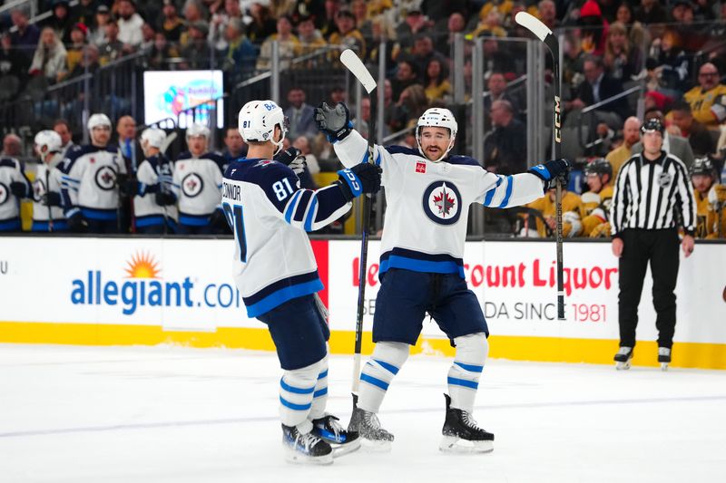 Nov 29, 2024; Las Vegas, Nevada, USA; Winnipeg Jets defenseman Neal Pionk (4) celebrates with Winnipeg Jets left wing Kyle Connor (81) after scoring a goal against the Vegas Golden Knights during the third period at T-Mobile Arena. Mandatory Credit: Stephen R. Sylvanie-Imagn Images