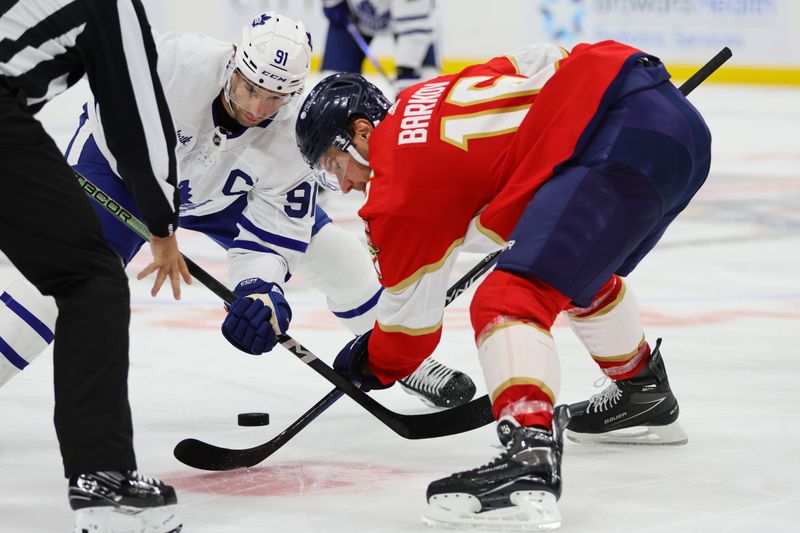 Apr 16, 2024; Sunrise, Florida, USA; Toronto Maple Leafs center John Tavares (91) and Florida Panthers center Aleksander Barkov (16) face-off during the third period at Amerant Bank Arena. Mandatory Credit: Sam Navarro-USA TODAY Sports