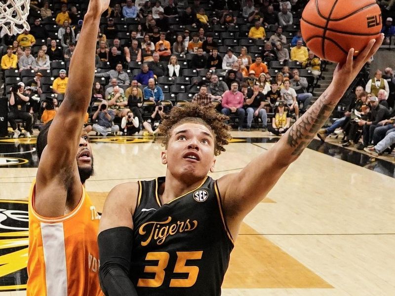 Feb 20, 2024; Columbia, Missouri, USA; Missouri Tigers forward Noah Carter (35) shoots as Tennessee Volunteers guard Zakai Zeigler (5) defends during the first half at Mizzou Arena. Mandatory Credit: Denny Medley-USA TODAY Sports