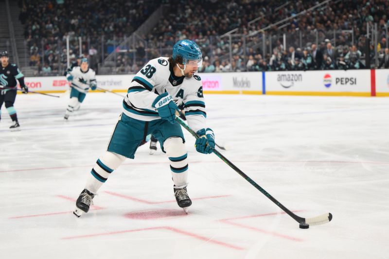 Jan 30, 2025; Seattle, Washington, USA; San Jose Sharks defenseman Mario Ferraro (38) plays the puck during the first period against the Seattle Kraken at Climate Pledge Arena. Mandatory Credit: Steven Bisig-Imagn Images