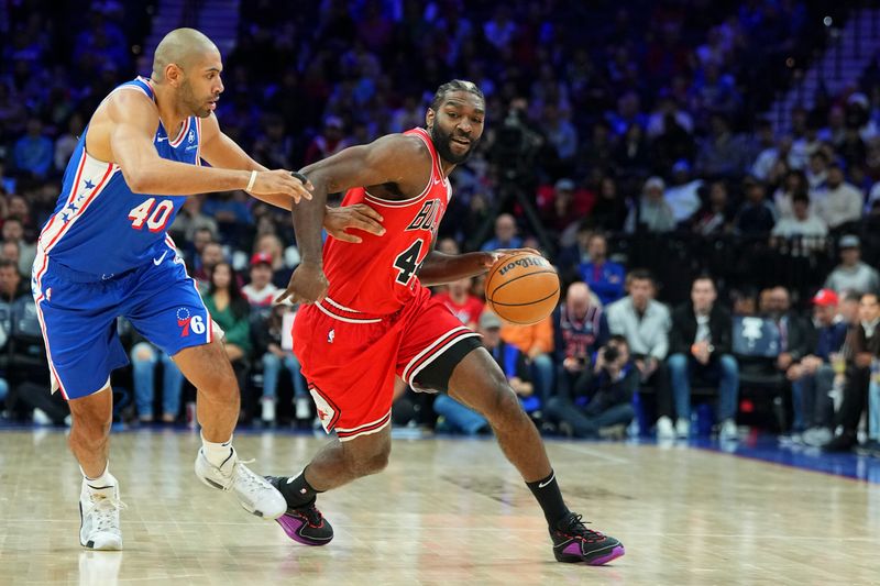 PHILADELPHIA, PENNSYLVANIA - JANUARY 2: Patrick Williams #44 of the Chicago Bulls dribbles the ball against Nicolas Batum #40 of the Philadelphia 76ers at the Wells Fargo Center on January 2, 2024 in Philadelphia, Pennsylvania. The 76ers defeated the Bulls 110-97. NOTE TO USER: User expressly acknowledges and agrees that, by downloading and or using this photograph, User is consenting to the terms and conditions of the Getty Images License Agreement. (Photo by Mitchell Leff/Getty Images)