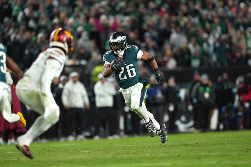 Philadelphia Eagles running back Saquon Barkley (26) runs with the ball during the second half of an NFL football game against the Washington Commanders Thursday, Nov. 14, 2024, in Philadelphia. (AP Photo/Matt Slocum)