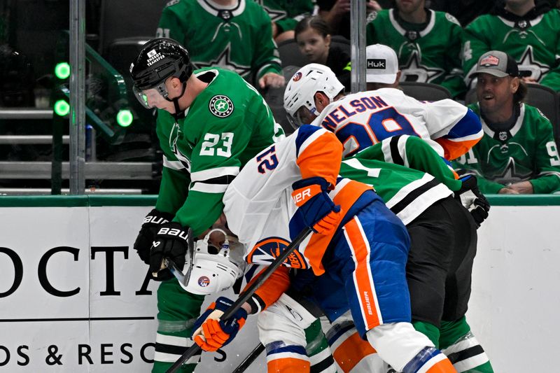 Oct 12, 2024; Dallas, Texas, USA; Dallas Stars defenseman Esa Lindell (23) knocks off the helmet of New York Islanders center Kyle Palmieri (21) during the third period at the American Airlines Center. Mandatory Credit: Jerome Miron-Imagn Images