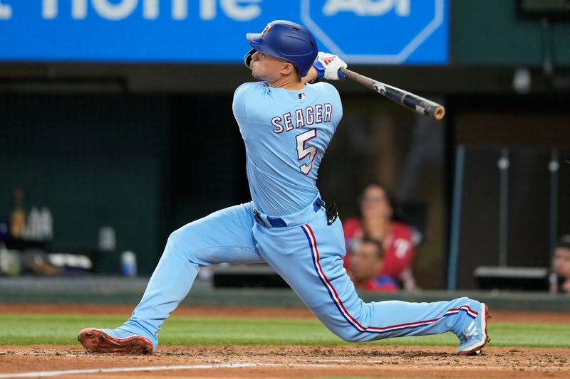 Aug 20, 2023; Arlington, Texas, USA; Texas Rangers shortstop Corey Seager (5) follows through on his solo home run against the Milwaukee Brewers during the third inning at Globe Life Field. Mandatory Credit: Jim Cowsert-USA TODAY Sports