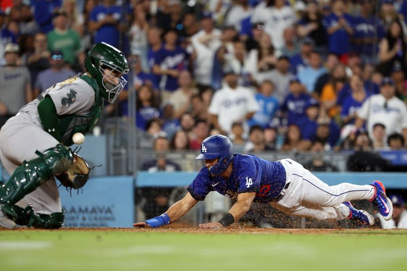 Aug 3, 2023; Los Angeles, California, USA;  Los Angeles Dodgers catcher Austin Barnes (15) beats the throw to Oakland Athletics catcher Shea Langeliers (23) to score a run in the sixth inning at Dodger Stadium. Mandatory Credit: Kiyoshi Mio-USA TODAY Sports