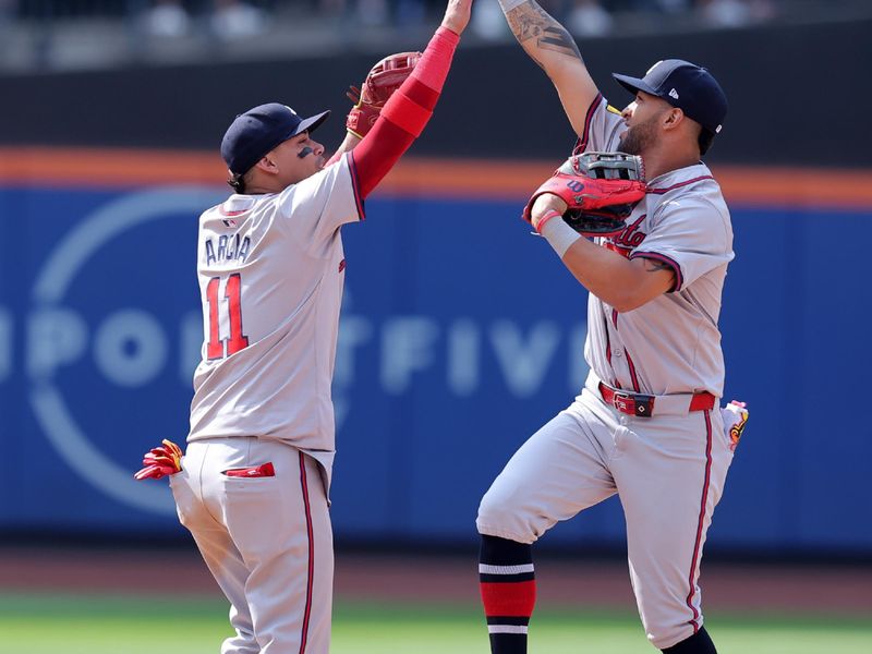 Jul 28, 2024; New York City, New York, USA; Atlanta Braves shortstop Orlando Arcia (11) and right fielder Eddie Rosario (8) celebrate after defeating the New York Mets at Citi Field. Mandatory Credit: Brad Penner-USA TODAY Sports