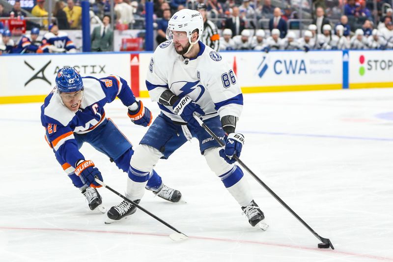 Feb 24, 2024; Elmont, New York, USA;  New York Islanders left wing Anders Lee (27) and Tampa Bay Lightning right wing Nikita Kucherov (86) battle for control of the puck in the first period at UBS Arena. Mandatory Credit: Wendell Cruz-USA TODAY Sports