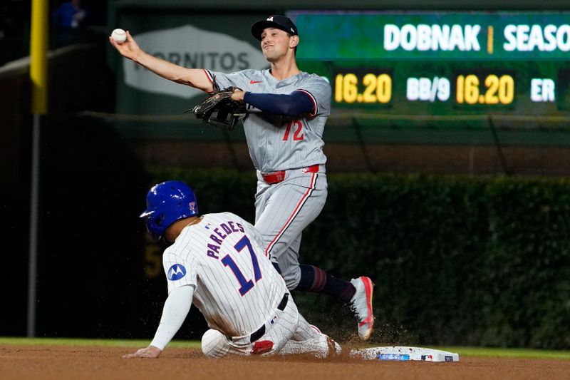 Aug 6, 2024; Chicago, Illinois, USA; Minnesota Twins second baseman Brooks Lee (72) forces out Chicago Cubs third baseman Isaac Paredes (17) during the sixth inning at Wrigley Field. Mandatory Credit: David Banks-USA TODAY Sports