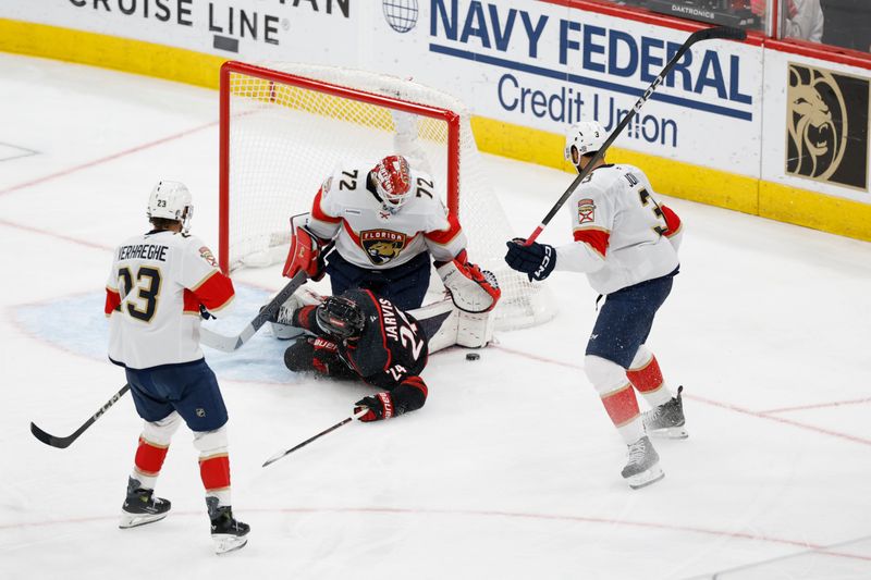 May 28, 2025; Raleigh, North Carolina, USA; Carolina Hurricanes forward Seth Jarvis (24) slides into Florida Panthers goaltender Sergei Bobrovsky (72) after being tripped by defenseman Seth Jones (3) during the second period in game five of the Eastern Conference Final of the 2025 Stanley Cup Playoffs at Lenovo Center. Mandatory Credit: Geoff Burke-Imagn Images