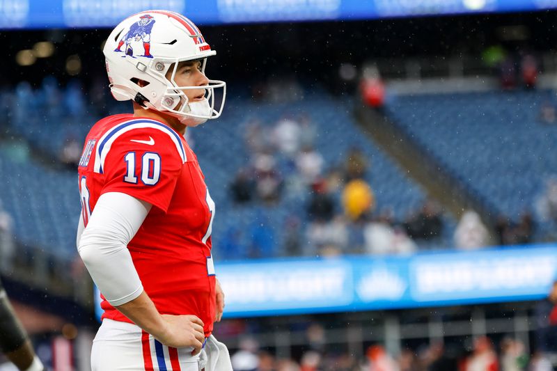 New England Patriots quarterback Mac Jones (10) reacts before an NFL football game against the Los Angeles Chargers on Sunday, Dec. 3, 2023, in Foxborough, Mass. (AP Photo/Greg M. Cooper)