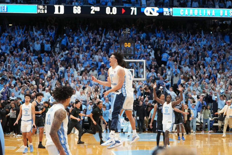 Feb 7, 2026; Chapel Hill, North Carolina, USA; North Carolina Tar Heels guard Seth Trimble (7) leaps with forward Zayden High (1) after the game at Dean E. Smith Center. Mandatory Credit: Bob Donnan-Imagn Images