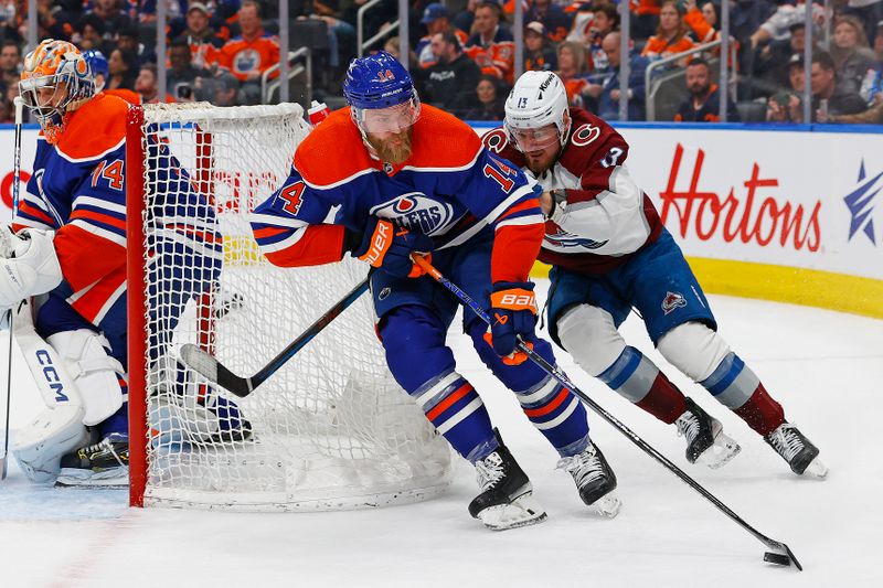 Mar 16, 2024; Edmonton, Alberta, CAN; Edmonton Oilers defensemen Mattias Ekholm (14) and Colorado Avalanche forward Valeri Nichushkin(13) battle for a loose puck during the second period at Rogers Place. Mandatory Credit: Perry Nelson-USA TODAY Sports