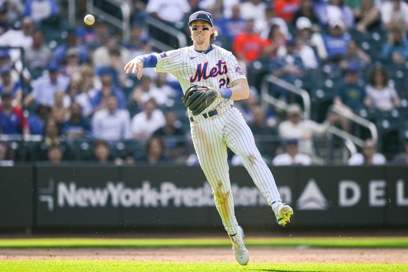 May 2, 2024; New York City, New York, USA; New York Mets third baseman Brett Baty (22) fields a ground ball and throws to first base for an out during the eleventh inning against the Chicago Cubs at Citi Field. Mandatory Credit: John Jones-USA TODAY Sports