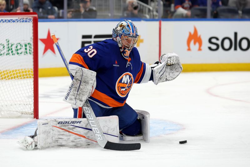 Dec 5, 2024; Elmont, New York, USA; New York Islanders goaltender Ilya Sorokin (30) plays the puck against the Seattle Kraken during the first period at UBS Arena. Mandatory Credit: Brad Penner-Imagn Images