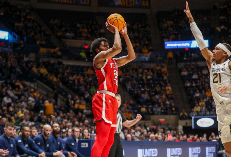 Mar 2, 2024; Morgantown, West Virginia, USA; Texas Tech Red Raiders guard Kerwin Walton (24) shoots over West Virginia Mountaineers guard RaeQuan Battle (21) during the first half at WVU Coliseum. Mandatory Credit: Ben Queen-USA TODAY Sports